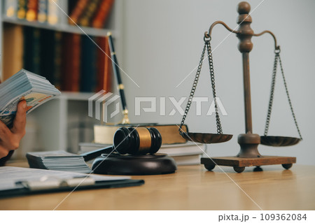 Lawyer, legal advisor, businessman brainstorming information on agreement details Business contracts in legal processing books for accuracy in contract documents. joint financial investment. 109362084