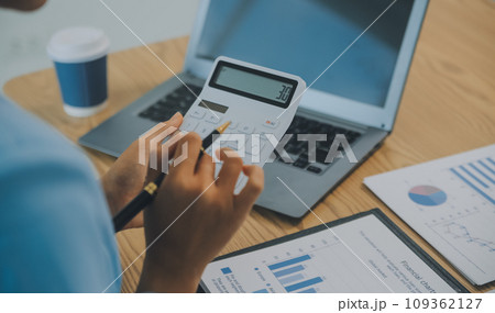 Business team working with new startup project plan and discussion information for financial strategy with laptop and digital tablet in a modern business lounge. Business team working with new startup project plan and discussion information for financial strategy with laptop and digital tablet in a modern business lounge. 109362127