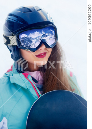 Close up Portrait of snowboarder in Carpathian Mountains, Bukovel Snowboarder. A mountain range reflected in the ski mask 109362200