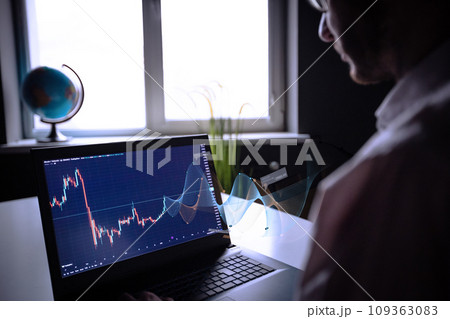 Businessman trading online stock market concept or forex investment exchange. Bitcoins, futures. Crypto currency chart with values moving up and down, trading statistics and analytics on laptop screen Businessman trading online stock market concept or forex investment exchange. Bitcoins, futures. Crypto currency chart with values moving up and down, trading statistics and analytics on laptop screen 109363083
