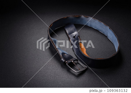 Old leather men's belt with an old-style metal buckle 109363132