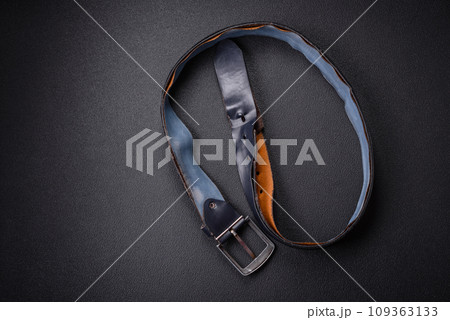 Old leather men's belt with an old-style metal buckle 109363133