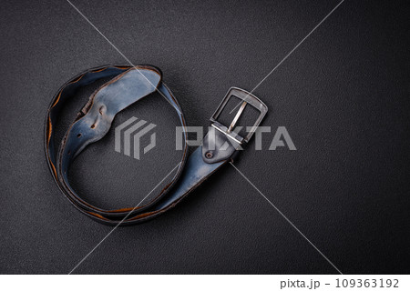 Old leather men's belt with an old-style metal buckle 109363192