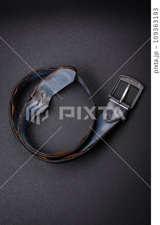 Old leather men's belt with an old-style metal buckle 109363193