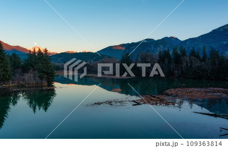 Canadian Mountain Landscape, peaceful river with green trees. Sunny Sunset. 109363814