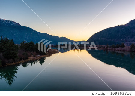 Canadian Mountain Landscape, peaceful river with green trees. Sunny Sunset. 109363816