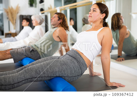 Young woman doing pilates with roller 109367412