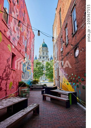 Alley with benches and chairs and wall art murals leading to Columbia City courthouse Alley with benches and chairs and wall art murals leading to Columbia City courthouse 109367555