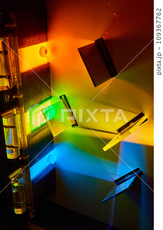 Different colored pieces of glass creating new colors of light in science experiment 109367762