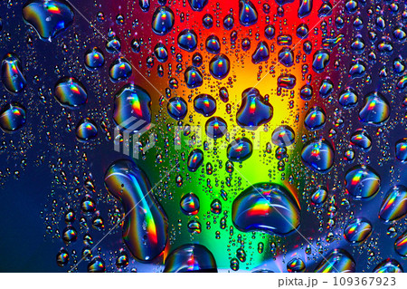 Rainbow colored beam of light through fizzy bubbles in underwater abstract background asset 109367923