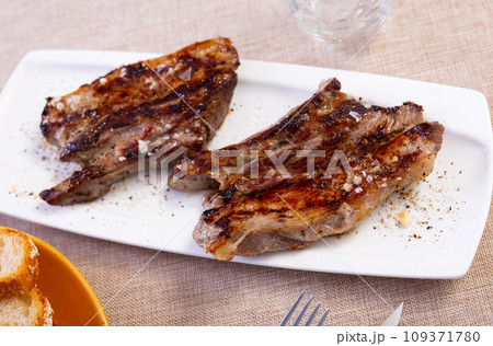 Veal meat cooked over open fire, with appetizing crust and dark stripes and traces from barbecue grill 109371780