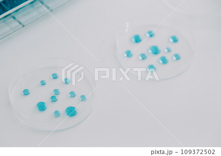 biochemical research scientist team working with microscope for coronavirus vaccine development in pharmaceutical research labolatory, selective focus 109372502