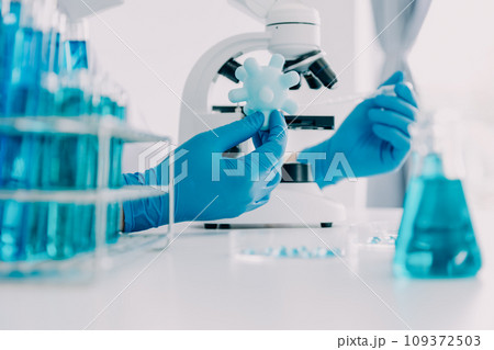 biochemical research scientist team working with microscope for coronavirus vaccine development in pharmaceutical research labolatory, selective focus biochemical research scientist team working with microscope for coronavirus vaccine development in pharmaceutical research labolatory, selective focus 109372503
