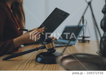 Lawyer, legal advisor, businessman brainstorming information on agreement details Business contracts in legal processing books for accuracy in contract documents. joint financial investment. 109372556