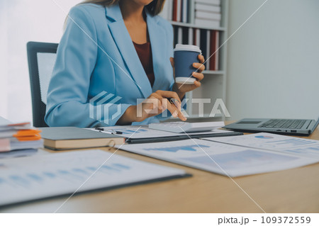 Business team working with new startup project plan and discussion information for financial strategy with laptop and digital tablet in a modern business lounge. 109372559