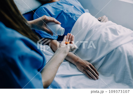 Doctor telling to patient woman the results of her medical tests. Doctor showing medical records to cancer patient in hospital ward. Senior doctor explaint the side effects of the intervention. 109373107