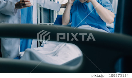 Doctor telling to patient woman the results of her medical tests. Doctor showing medical records to cancer patient in hospital ward. Senior doctor explaint the side effects of the intervention. 109373134