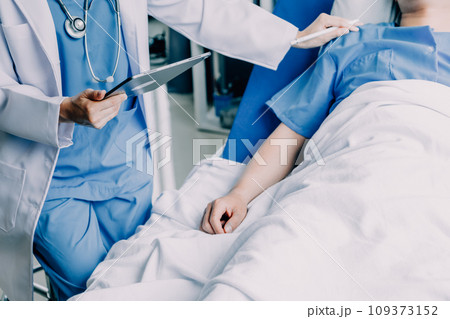 Doctor telling to patient woman the results of her medical tests. Doctor showing medical records to cancer patient in hospital ward. Senior doctor explaint the side effects of the intervention. 109373152
