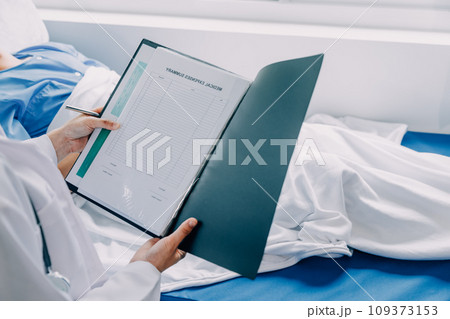 Doctor telling to patient woman the results of her medical tests. Doctor showing medical records to cancer patient in hospital ward. Senior doctor explaint the side effects of the intervention. 109373153