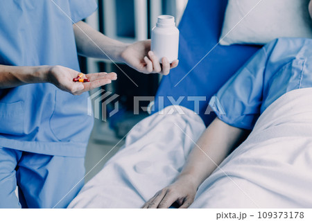 Doctor telling to patient woman the results of her medical tests. Doctor showing medical records to cancer patient in hospital ward. Senior doctor explaint the side effects of the intervention. 109373178