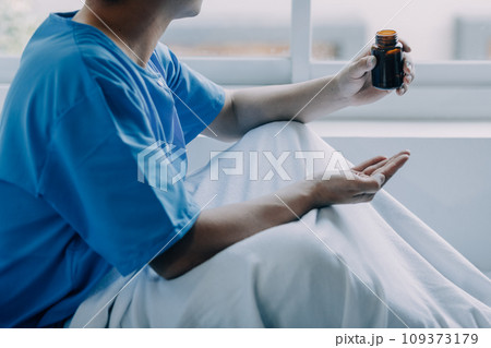 Terminally Ill Male Patient Lies on a Bad In the Hospital. Melancholy and Exhausted Patient in the Palliative Care Ward. 109373179