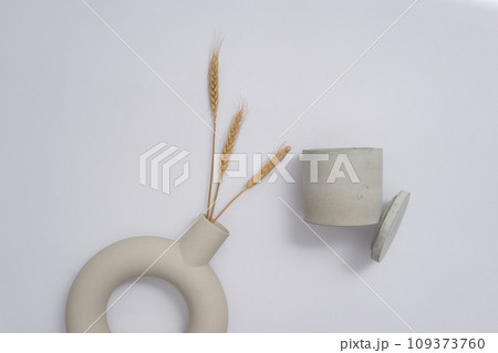 An open jar of unbranded scented candles is displayed on a white background with decorations. Empty space for text design. Scented candles are commonly used to scent a space. 109373760
