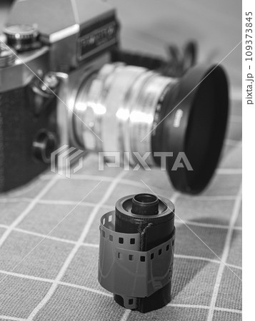 classic 135 film cassette with retro camera background   109373845