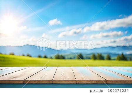 Empty wood tabletop or counter with display product. Blur image of blue sky and hill background. Display product background 109375084