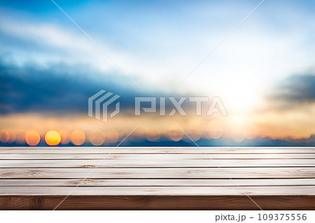 Empty wood tabletop or counter with display product. Blur image of blue sky and hill background. Display product background Empty wood tabletop or counter with display product. Blur image of blue sky and hill background. Display product background 109375556