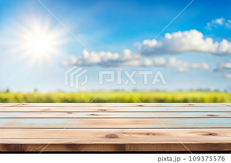 Empty wood tabletop or counter with display product. Blur image of blue sky and hill background. Display product background Empty wood tabletop or counter with display product. Blur image of blue sky and hill background. Display product background 109375576