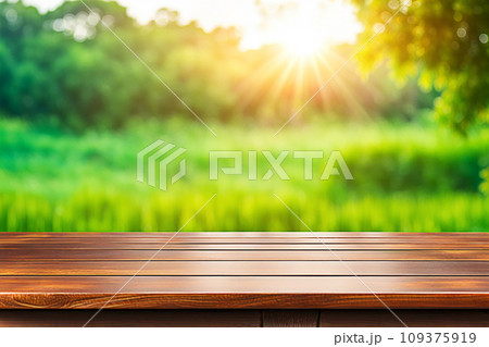 Empty wood tabletop or counter with display product. Blur image of green leaves bokeh background. Display product background concept Empty wood tabletop or counter with display product. Blur image of green leaves bokeh background. Display product background concept 109375919