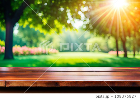 Empty wood tabletop or counter with display product. Blur image of green leaves bokeh background. Display product background concept Empty wood tabletop or counter with display product. Blur image of green leaves bokeh background. Display product background concept 109375927