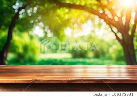 Empty wood tabletop or counter with display product. Blur image of green leaves bokeh background. Display product background concept 109375931
