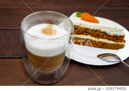 Carrot sponge cake with cream and walnuts and Cappuccino coffee Carrot sponge cake with cream and walnuts and Cappuccino coffee 109379408
