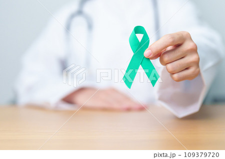 Doctor holding Teal Ribbon for January Cervical Cancer Awareness month. Uterus and Ovaries, Cervix, Endometriosis, Hysterectomy, Uterine fibroids, Reproductive, Healthcare and World cancer day 109379720