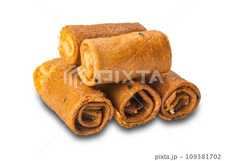 Pile of crispy delicious homemade coconut roll isolated on white background. Pile of crispy delicious homemade coconut roll isolated on white background. 109381702