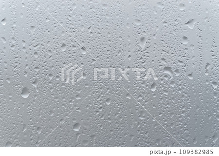 Water drops on a window glass Water drops on a window glass 109382985