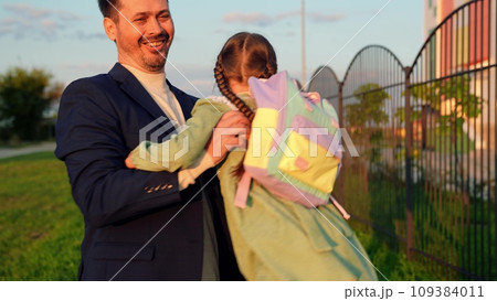 educational program, father daughter spins, child, kid, father, schoolgirl running outdoors, happy family, girl running from class, recess, daughter, child school backpack runs across school yard educational program, father daughter spins, child, kid, father, schoolgirl running outdoors, happy family, girl running from class, recess, daughter, child school backpack runs across school yard 109384011