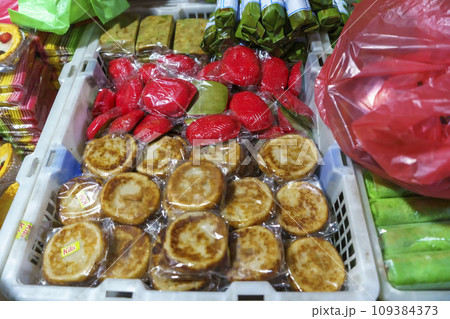 Many varieties of traditional snacks sold in the Marketplace in dawn time in Surabaya, East Java, Indonesia. Many varieties of traditional snacks sold in the Marketplace in dawn time in Surabaya, East Java, Indonesia. 109384373