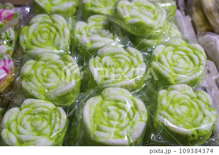 Many varieties of traditional snacks sold in the Marketplace in dawn time in Surabaya, East Java, Indonesia. Many varieties of traditional snacks sold in the Marketplace in dawn time in Surabaya, East Java, Indonesia. 109384374