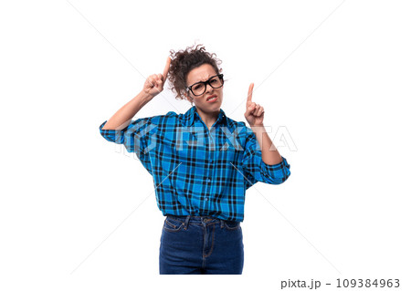 a young brunette woman with glasses is dressed in a loose-fitting blue plaid shirt a young brunette woman with glasses is dressed in a loose-fitting blue plaid shirt 109384963