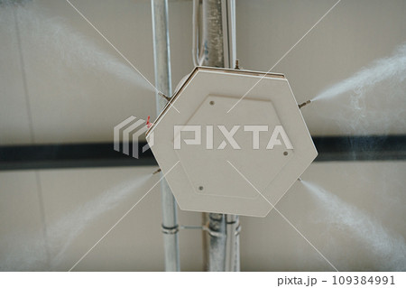 Industrial dust control system in modern manufacturing factory. Dust suppression with water mist, creating fine water mist, moistening dust particles. Industrial dust control system in modern manufacturing factory. Dust suppression with water mist, creating fine water mist, moistening dust particles. 109384991