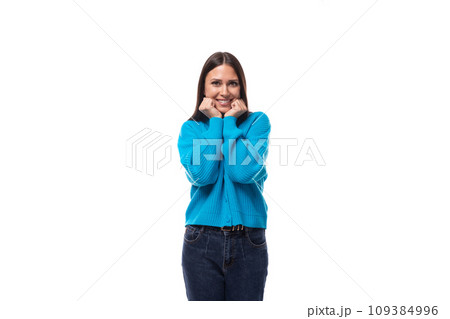 young pleasantly surprised pretty european brunette woman dressed in a blue button-down sweater young pleasantly surprised pretty european brunette woman dressed in a blue button-down sweater 109384996