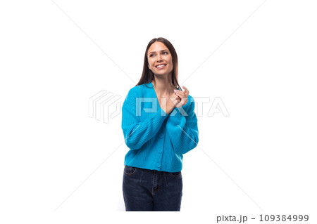 young well-groomed brunette woman dressed in a blue cardigan on a white background with copy space young well-groomed brunette woman dressed in a blue cardigan on a white background with copy space 109384999