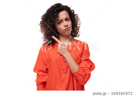 young stylish curly caucasian brunette woman dressed in orange blouse young stylish curly caucasian brunette woman dressed in orange blouse 109385972