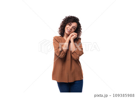 young cheerful pleasant slender woman with curls dressed in a brown shirt young cheerful pleasant slender woman with curls dressed in a brown shirt 109385988