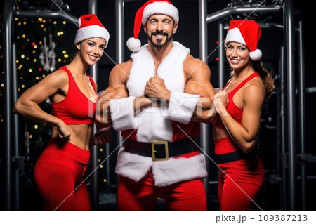 Santa Claus fitness trainers. A muscular man and two women in a gym Santa Claus fitness trainers. A muscular man and two women in a gym 109387213