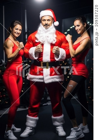 Santa Claus fitness trainers. A muscular man and two women in a gym Santa Claus fitness trainers. A muscular man and two women in a gym 109387220
