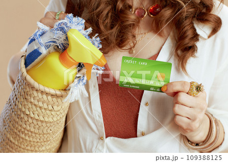 Modern woman in blouse and shorts isolated on beige 109388125