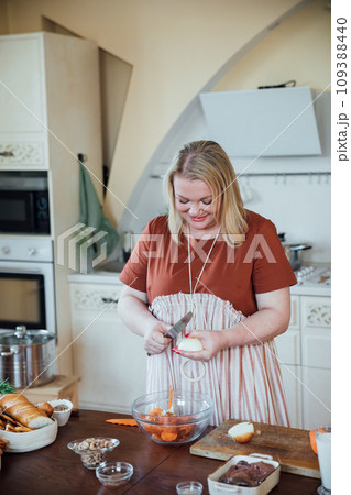 Female housewife in kitchen cooking food from vegetables 109388440